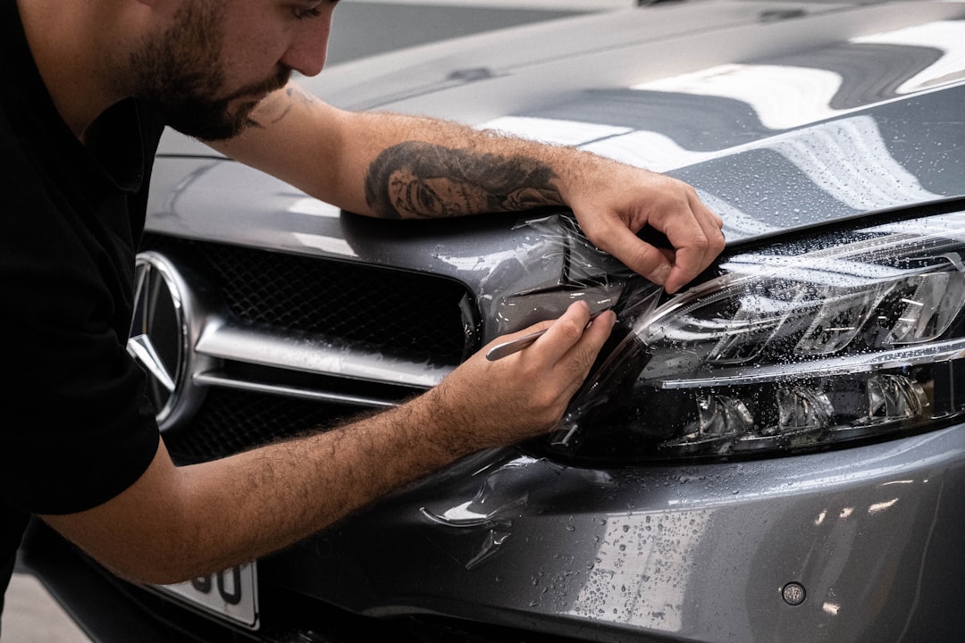 a-man-waxing-the-hood-of-a-car-dljelfmdpoc