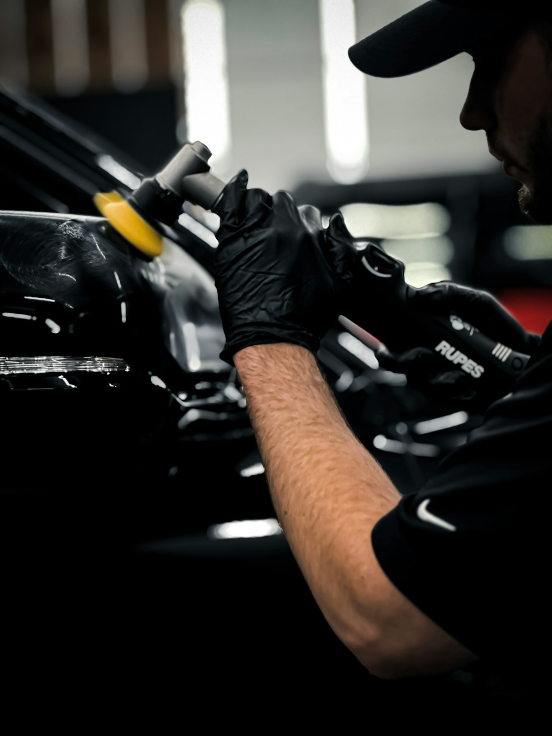 a-man-working-on-a-car-in-a-garage-wtw51lupc6k